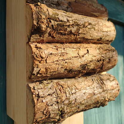 Macro detail of the thick untreated bark-on logs and the narrow gaps between them